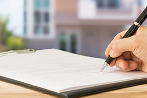 business seller signing a document 