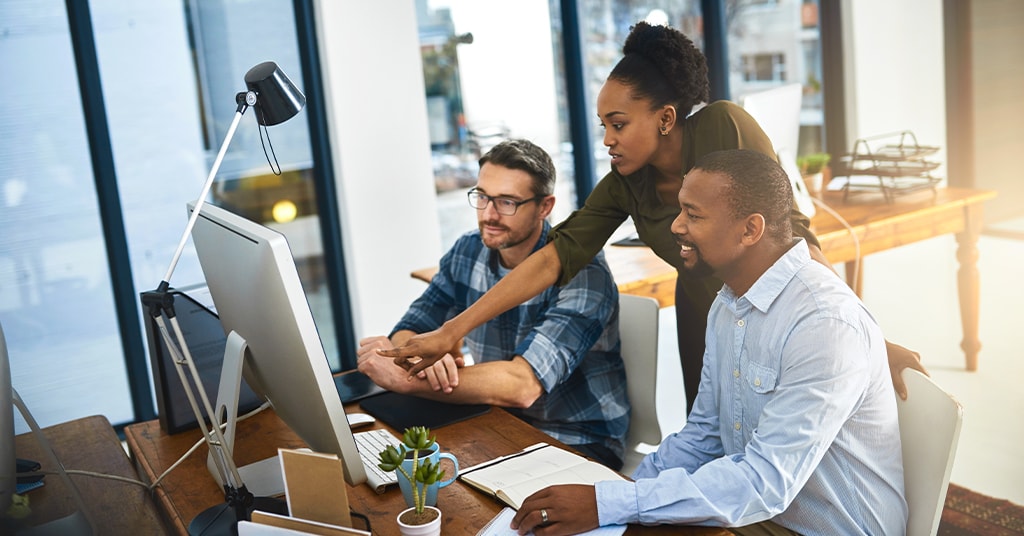 team group going over information on computer