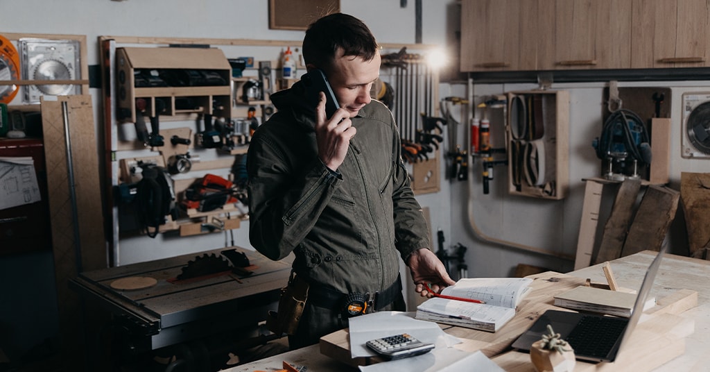 gentleman on the phone talking to someone in office