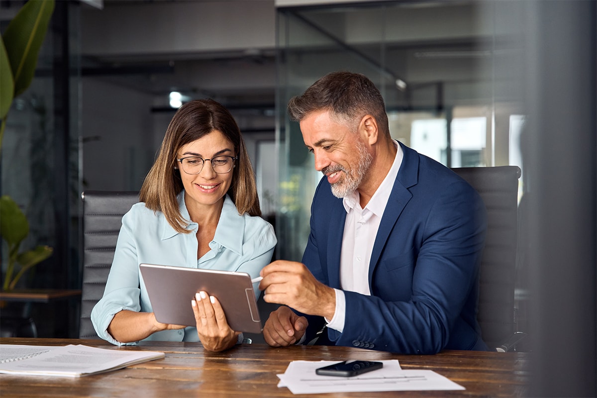 two business looking at tablet