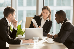 business team going over paperwork during meeting