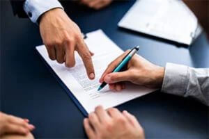 A business owner signing documents about a family business