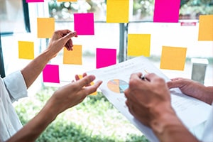 close up of hands brainstorming business ideas