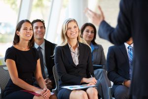 A group of people listening to a sales pitch.