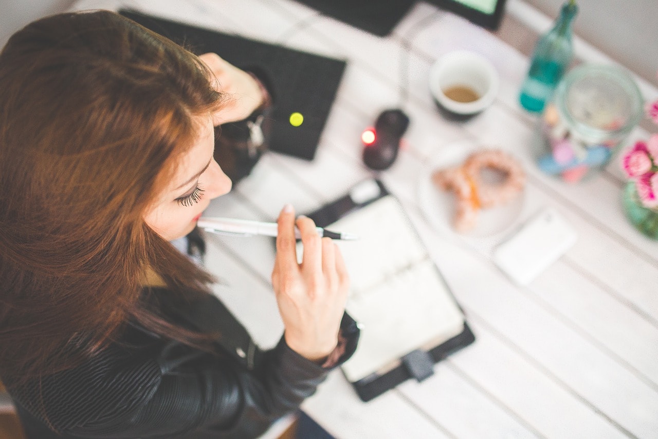 A woman contemplating when to buy a business.