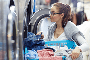 woman using machine at laundromat business