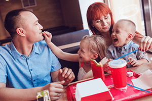 family eating at fast food restaurant table