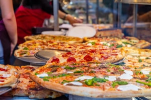 pizzas with different toppings available in a pizzeria