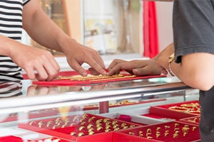 pawn shop worker showing rings to customer