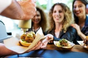 food truck employee serving food to customers
