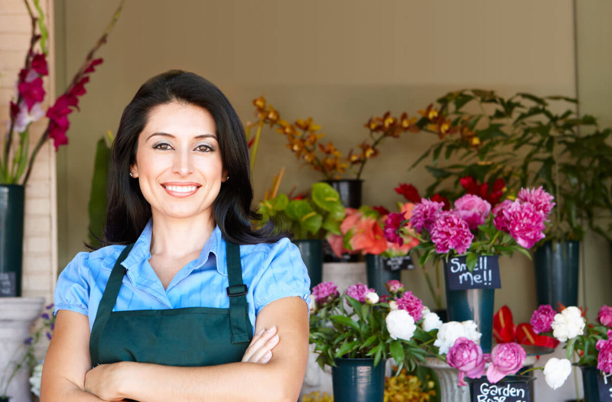woman smiling in her flower shop business