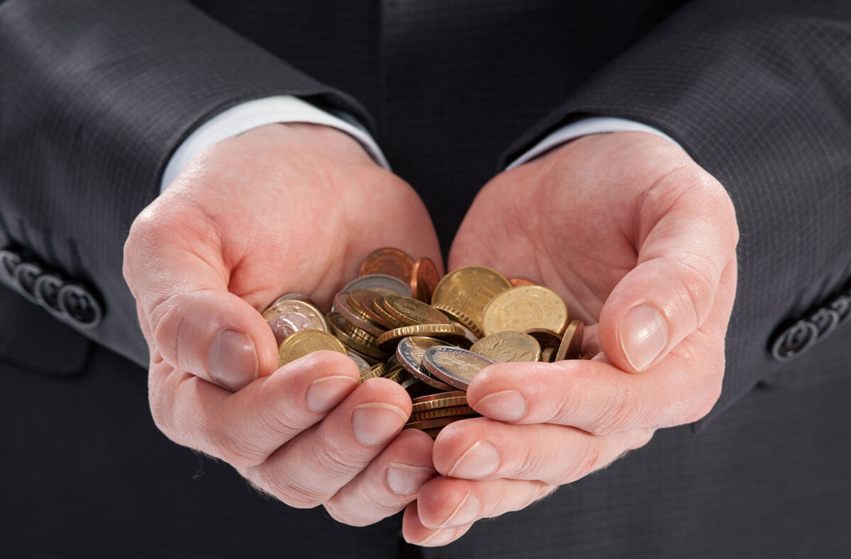 businessman holding coins in his hand