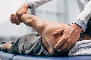 chiropractor aligning patient's shoulder