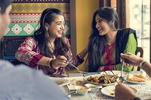 friends eating at indian restaurant