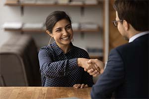 woman accepting an offer on her small business after working with a broker