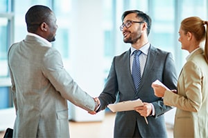 Men in suits shaking hands in business deal