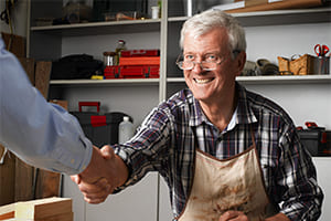 a main street business owner shaking hands with a buyer