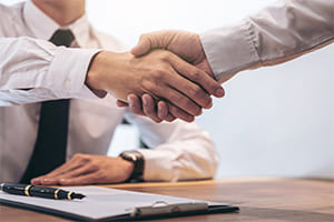 a business buyer and seller shaking hands